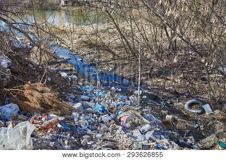 Garbage Thrown To The Bank Of The River, The Topic Of Environmental Pollution