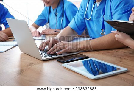 Medical Students Studying At Table, Closeup View