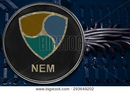 The Coin Cryptocurrency Xem On The Background Of Wires And Circuits. Crypto Token Xem.