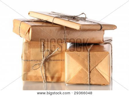 Many parcels wrapped in brown paper tied with twine isolated on white