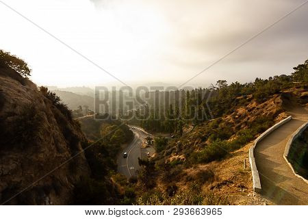 Hilside View Of Road Leading Into Hills From Hiking Path.