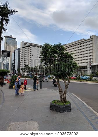 Jakarta, Indonesia - February 16, 2019: A Family Walking On The Pavement Of Jalan Thamrin (thamrin S