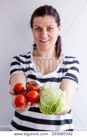 Woman Holds Healthy Vegan Products In Her Hands