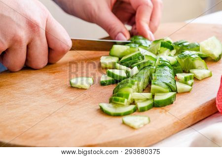 Woman Hands Cutting Vegetables On Wooden Background
