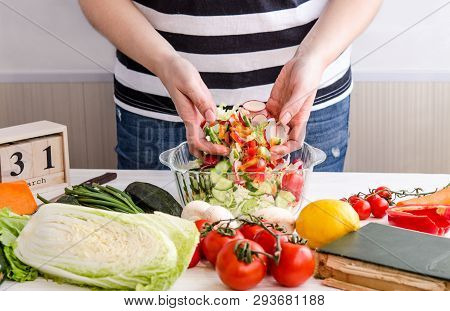 Woman Hands Adding Vegetables To Dishes