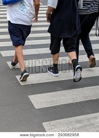 Jakarta, Indonesia - February 16, 2019: Some People Walking On The Pelican Crossing On Jalan Thamrin