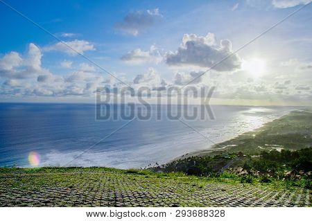 Paragliding Hill Watugupit At Yogyakarta, Beautiful View Of Hill And Sea With Blue Sky And Clouds