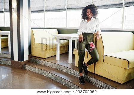 Сheerful Business African American Lady With Afro Hair, Wear White Blouse And Green Pants Posed In C