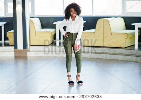 Сheerful Business African American Lady With Afro Hair, Wear White Blouse And Green Pants Posed In C