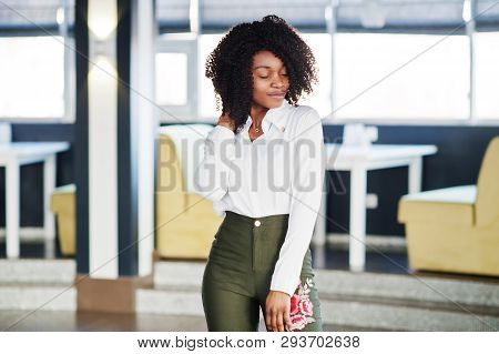 Сheerful Business African American Lady With Afro Hair, Wear White Blouse And Green Pants Posed In C