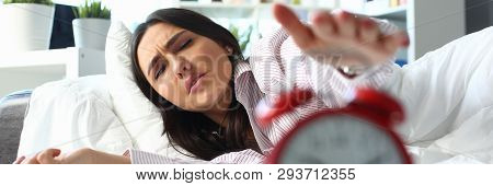 Sleepy Young Woman Portrait With One Opened Eye Trying Kill Alarm Clock. Early Wake Up Not Getting E