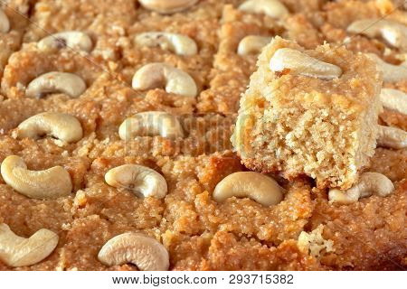 Basbousa Or Namoora Traditional Arabic Semolina Cake With Cashew Nuts And Syrup. Selective Focus. Cl