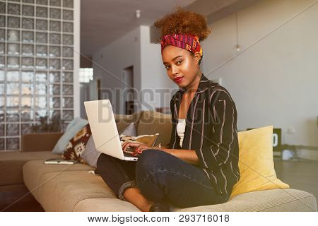 Cute American African Female Blogger Working Remotely On Digital Netbook With Internet Text. African