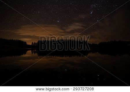 Night Sky With Starts In A  Conemara Lake With Pine Forest Around