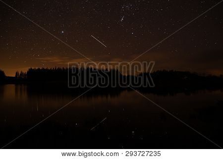 Night Sky With Starts In A  Conemara Lake With Pine Forest Around