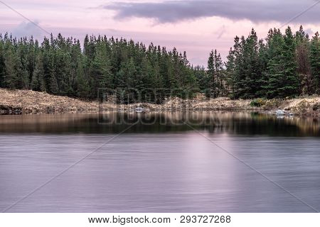 Sunset In Conemara Lake With Pine Forest Around
