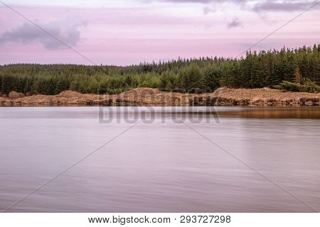 Sunset In Conemara Lake With Pine Forest Around