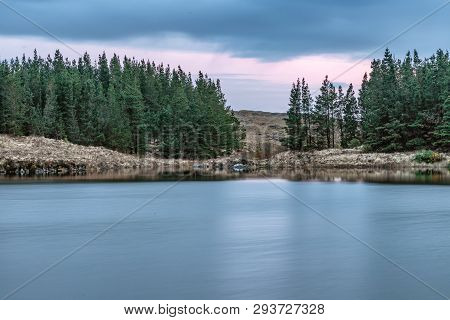 Sunset In Conemara Lake With Pine Forest Around