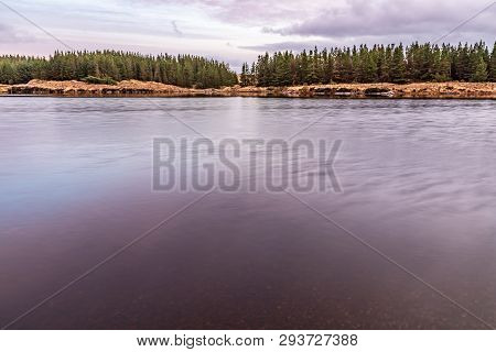 Sunset In Conemara Lake With Pine Forest Around