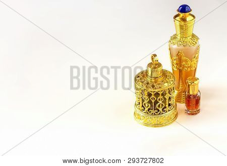 Traditional Golden Ornate Flask Of Arabian Oud Oil Perfumes. Isolated White Background. Copy Space.