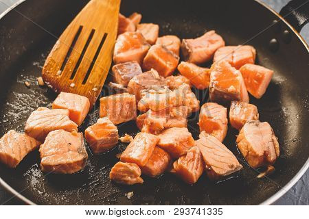 Diced Salmon Slices Are Fried In Frying Pan For Pasta With Creamy Salmon