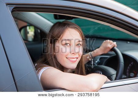 A Teenage Girl Drives In A Car