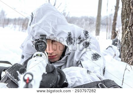 Closeup Portrait Man Soldier In The Winter On A Hunt With A Sniper Rifle In White Winter Camouflage