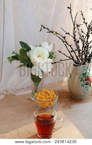 A Mug Of Tea, A Cup Of Corn And A Cake On A Sunny Table, A Bouquet Of Spring Flowers For Mood, Diet 