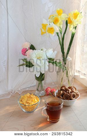 A Mug Of Tea, A Cup Of Corn And A Cake On A Sunny Table, A Bouquet Of Spring Flowers For Mood, Diet 
