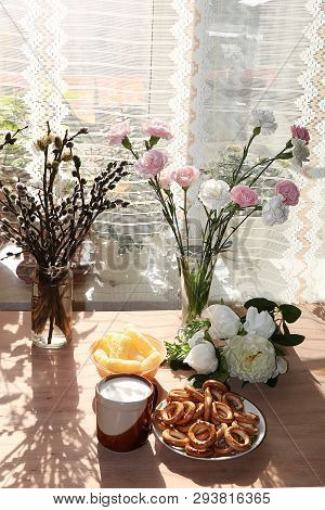 A Mug Of Milk, A Cup Of Corn And Cake On A Sunny Table, A Bouquet Of Spring Flowers For Mood, Diet F