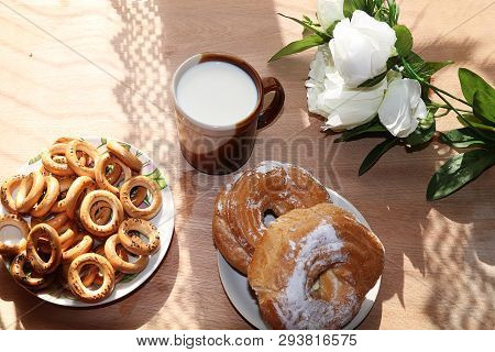 A Mug Of Milk, A Cup Of Corn And Cake On A Sunny Table, A Bouquet Of Spring Flowers For Mood, Diet F