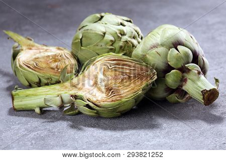 Artichokes On Rustic Background. Fresh Organic Artichoke Flower Set