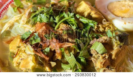 Soto Ayam Is A Chicken Soup Served With Vegetables And Rice - Image