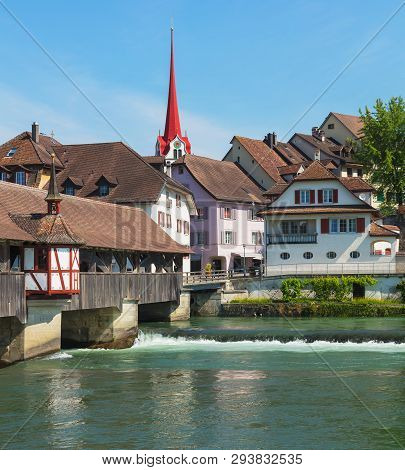 Medieval Covered Bridge Over The Reuss River, Buildings Of The Historic Part Of The Town Of Bremgart