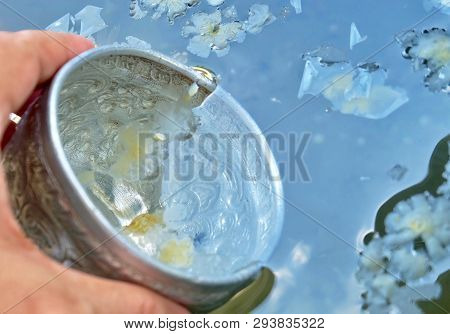 Buddhist Hand Holding A Small Bowls Scoops Up The Holy Water Or Blessed Water, Used To Drink, Cleani