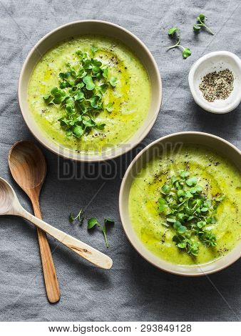 Mashed Spring Vegetable Soup Served With Micro Greens And Whole Grain Crackers On A Gray Background,