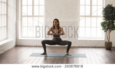 Attractive Woman Practicing Yoga, Standing In Sumo Squat, Goddess