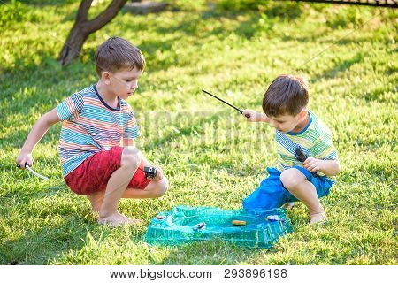Two Boys Playing With A Spinning Top Kid Toy. Popular Children Game Tournament.
