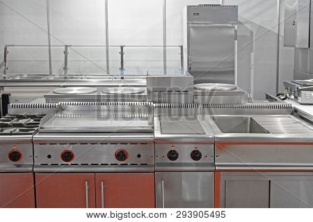 Interior Of Restaurant Commercial Kitchen With Stainless Steel Equipment
