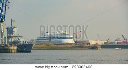 Hamburg, Germany - March 30, 2019: Military Ship And Cruise Ship Lie In Hamburg Harbor At The Contai