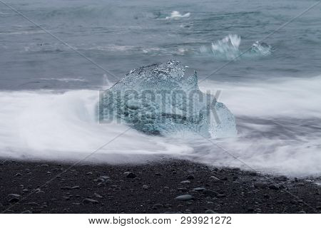 Amazing Transparent Blue Iceberg Pieces On Diamond Beach With Black Sand Near Jokulsarlon Lagoon, Ic