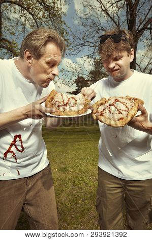 Men In Street Park Eating Langos With Garlic, Ketchup And Cheese
