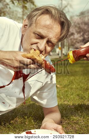 Men In Street Park Eating Langos With Garlic, Ketchup And Cheese