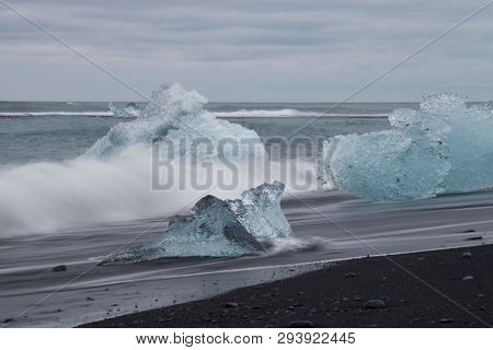 Amazing Transparent Blue Iceberg Pieces On Diamond Beach With Black Sand Near Jokulsarlon Lagoon, Ic