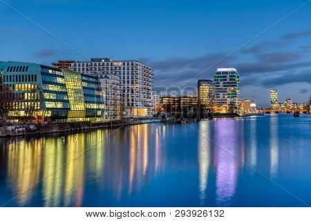 The River Spree In Berlin At Night With Modern Buildings At The River Banks