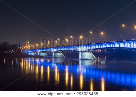 Slasko-dabrowski Bridge Over Vistula River At Night In Warsaw, Poland.