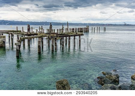 A View Of Decaying Pilings Along The Shore In Ruston, Washington Near Tacoma.