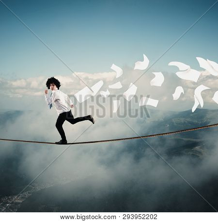 Young Man Runs Away From Bills On A Rope, Above Clouds And Mountains. The Concept Of Getting Rid Of 