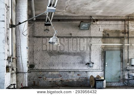 Lamp At A Workplace In A Disused Abandoned Workshop