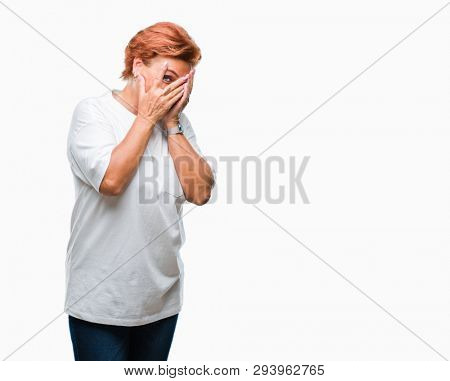 Atrractive senior caucasian redhead woman over isolated background with sad expression covering face with hands while crying. Depression concept.